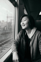 teen girl looking out a train window 
