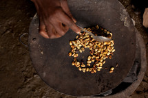 a woman preparing food in a bowl in Africa 
