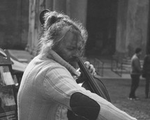 a man playing a cello on the streets of Rome 