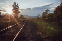 sunburst over train tracks 