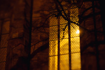glowing light in a church window at night 