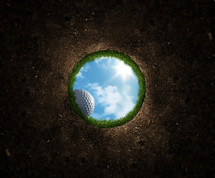 golf ball rolling into a hole