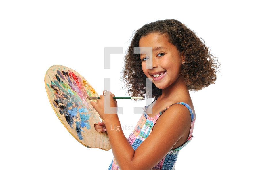 girl child holding a paint pallet 