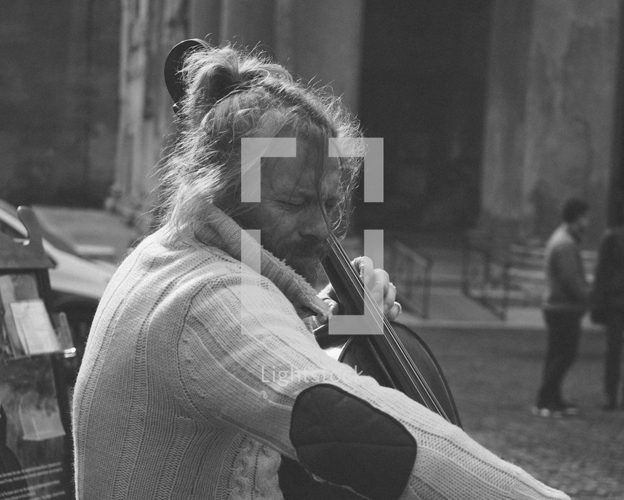 a man playing a cello on the streets of Rome 