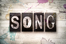 word song on a white wash wood background 