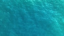 Aerial view of a blue sea water background. Flight over the sea. Aerial top down shot, 4K. 