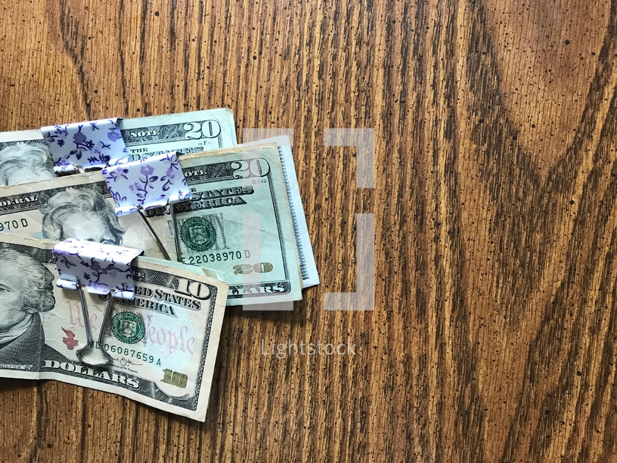 budgeted cash in money clips 