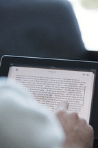 A man reading from an iPad 