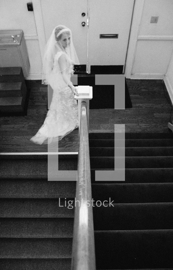 a bride walking down stairs 