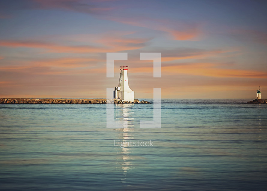 a distant lighthouse at sunset 