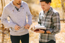 Two Guys Studying the bible outside during Fall 