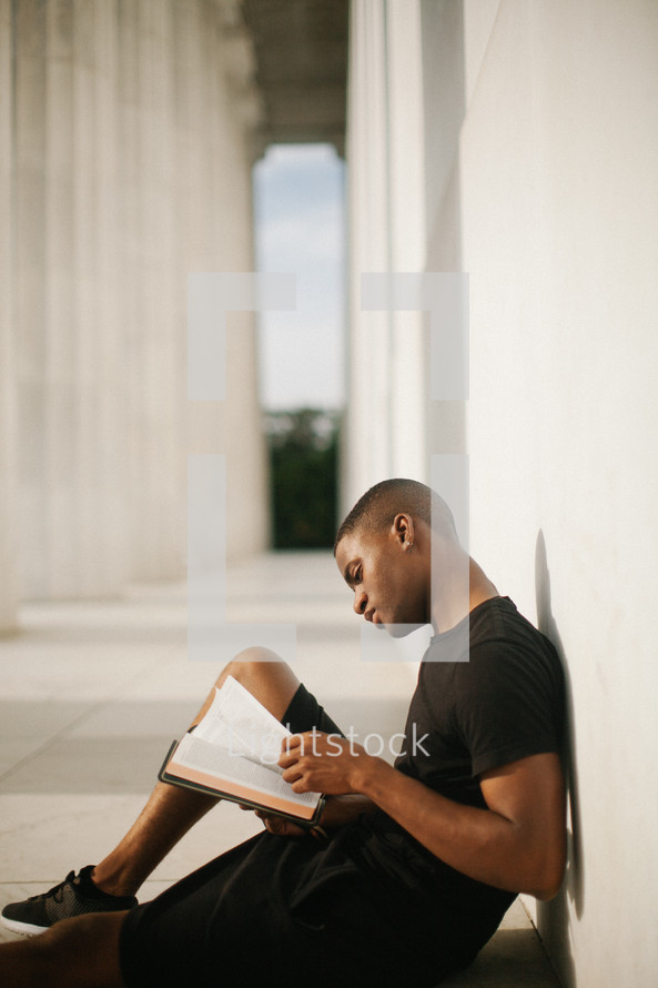 an African American man reading a Bible 