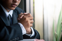 a man praying over an open Bible 