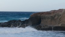 Ocean waves crash on the rock