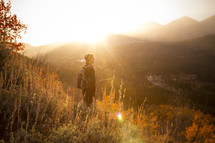 a man backpacking under bright sunlight 
