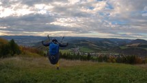 Paragliding takeoff in autumn countryside mountains adrenaline adventure freedom
