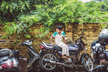 child sitting on a motorcycle 
