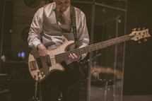A man on stage playing the bass