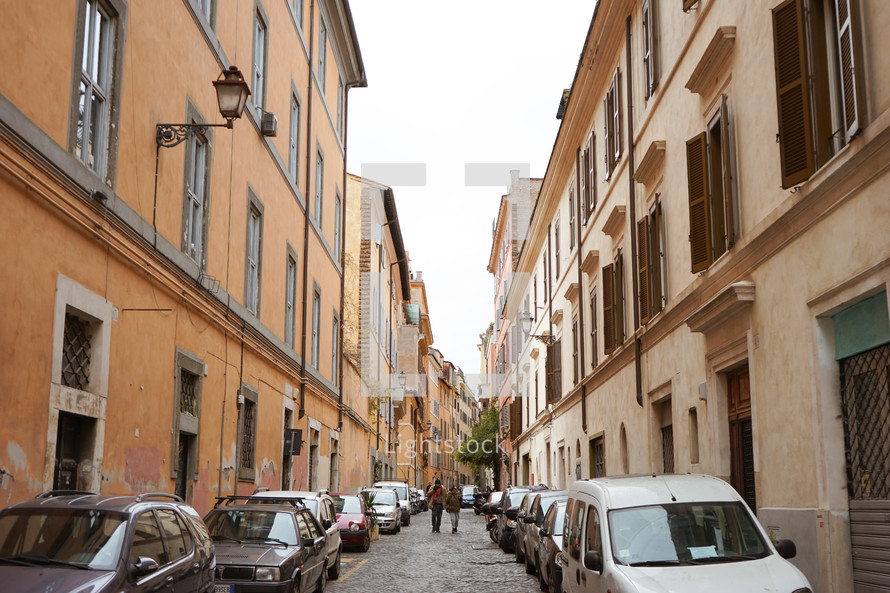 compact cars parked on a narrow street in Rome 