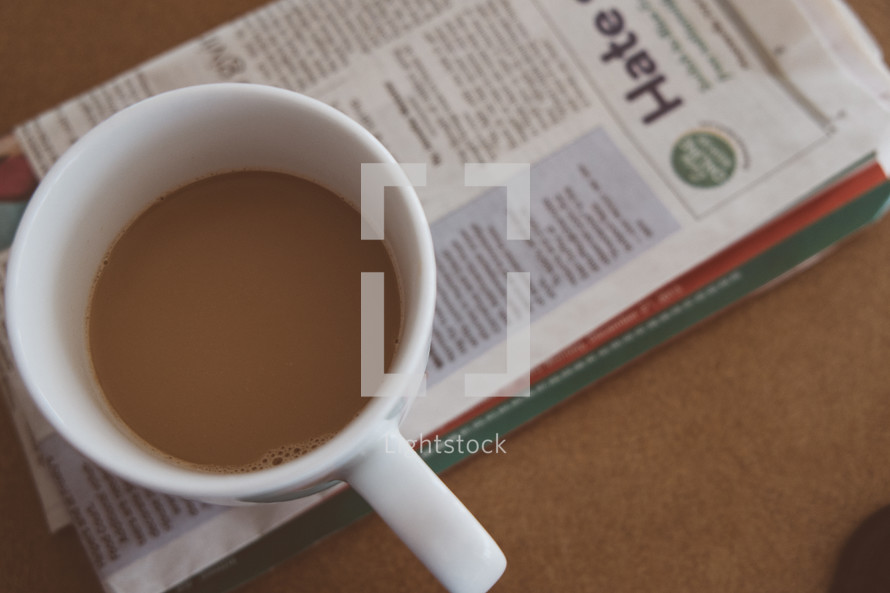 coffee mug on a newspaper 