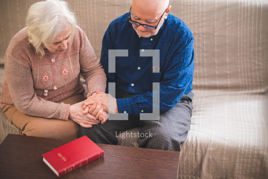 a senior couple reading a Bible together 