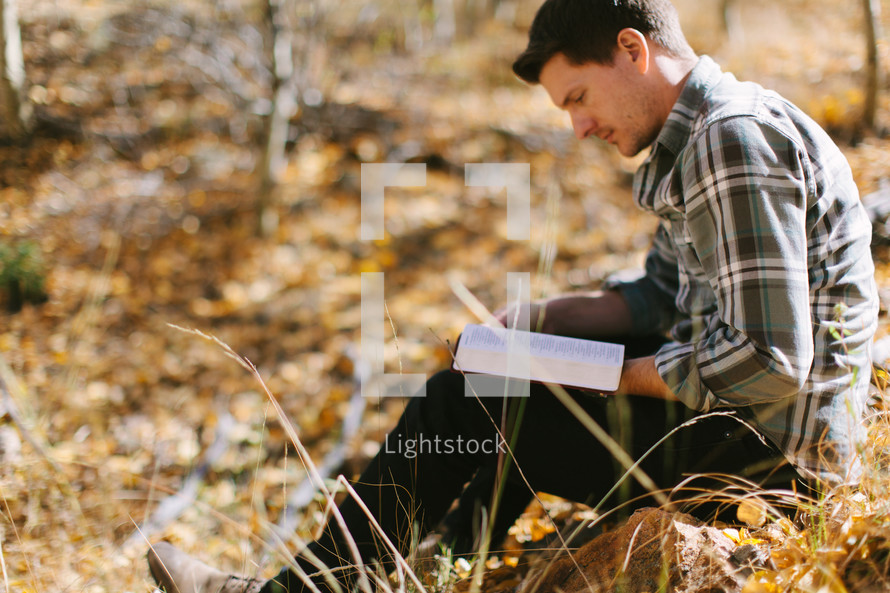 man reading outdoors 