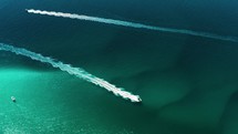 Drone footage of two boats passing in the ocean