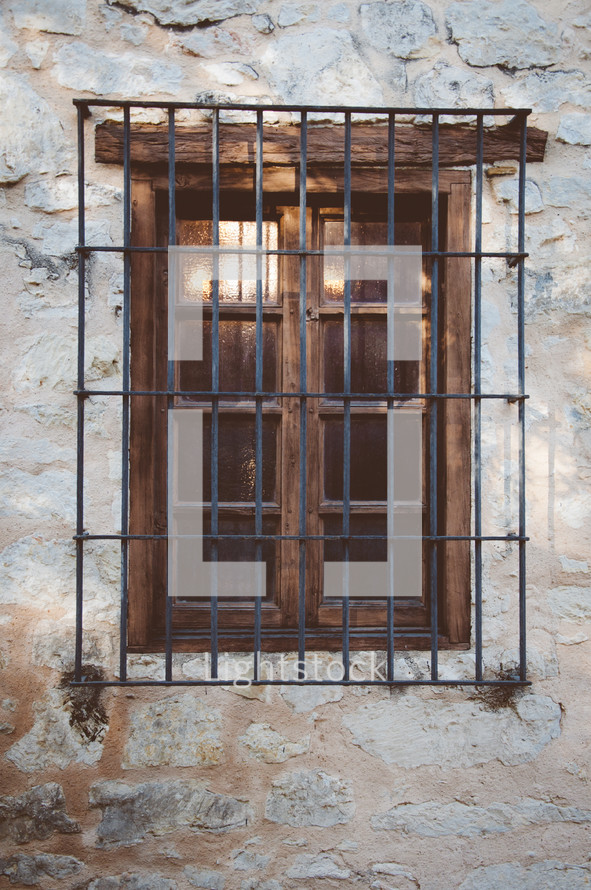 Iron bars over a wooden window.