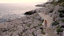 Girl walking besides the sea in South of France