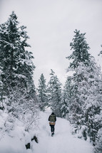 a woman walking through thick snow 