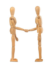 Two wooden dummies shake hands on white background