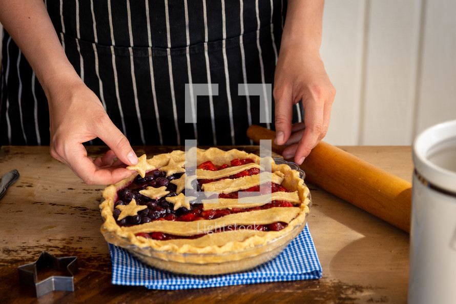 a woman baking a pie for July 4th 