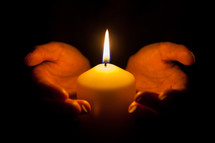 holding a burning candle 