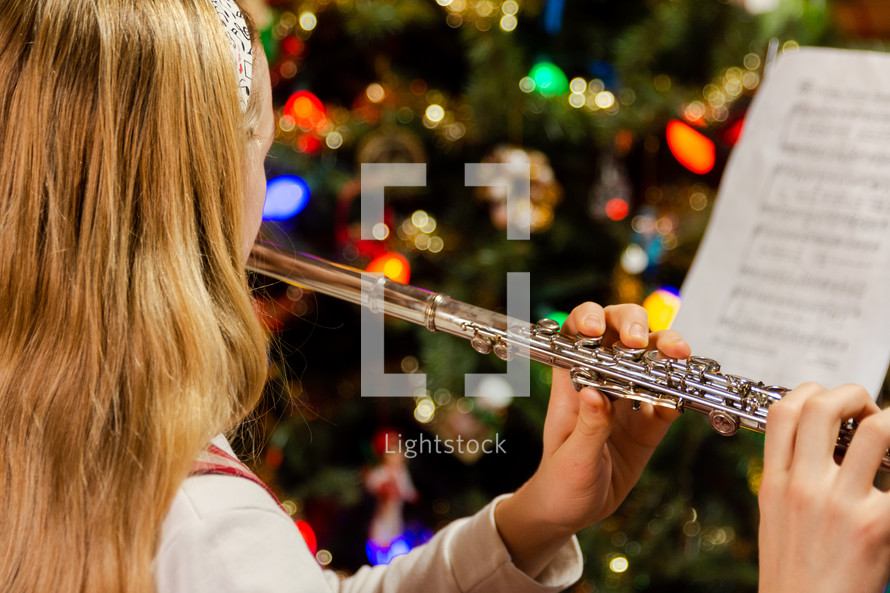 A girl playing the flute at Christmas time