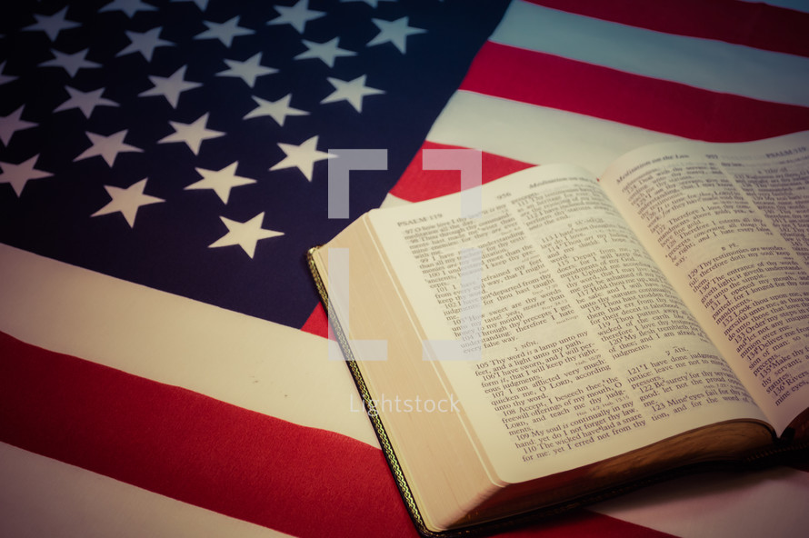 open Bible on an American flag 