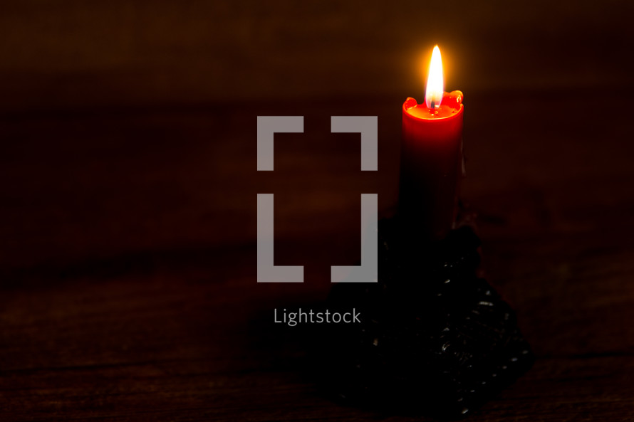 a candle stick with a wood background