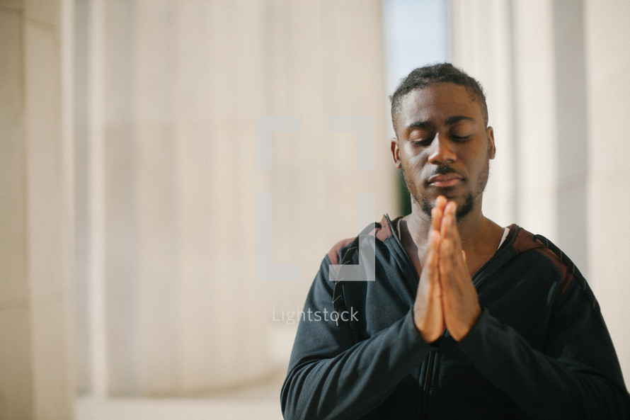 African American man with praying hands 