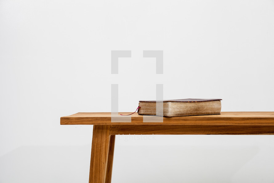 a Bible on a wood table 