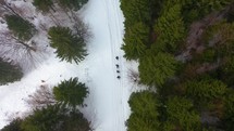aerial view over people hiking in the snow 