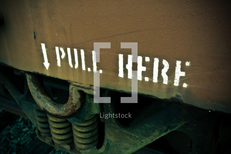 Pull Here and arrow sign on the side of a box car