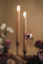 candlesticks and purple flowers 