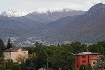 snow capped mountains above a small city 