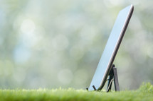 tablet on a stand on grass