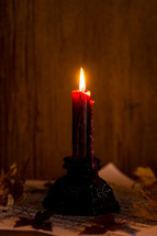 a candle with leaves and music