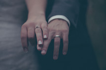 wedding rings on the hands of a bride and groom 