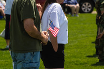 man and woman standing in respect at a Memorial day ceremony