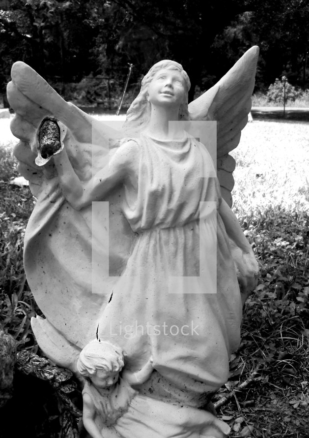 broken angel statue in a cemetery 