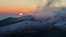 Colorful sunrise over winter mountains hidden in clouds Time lapse
