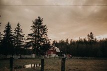red barn under a cloudy sky 
