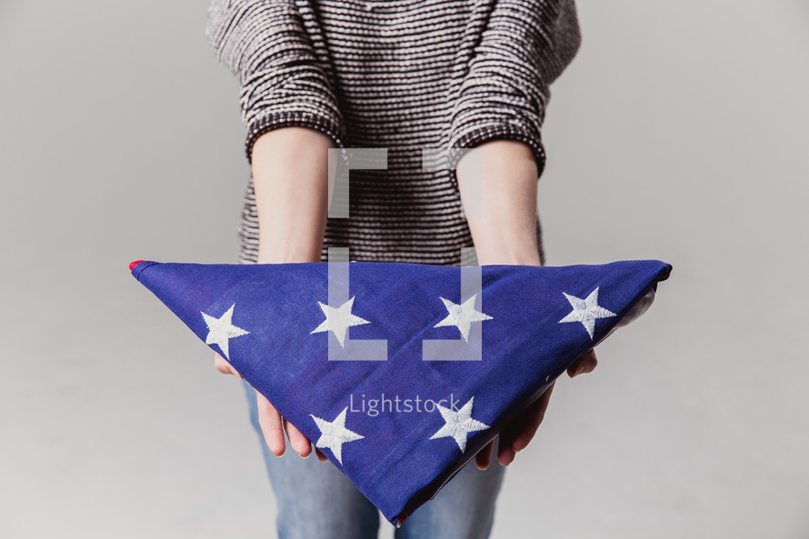 woman holding an American flag 